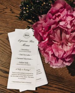 fresh flowers and espresso bar menu on a private event space table