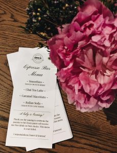 fresh flowers and espresso bar menu on a private event space table