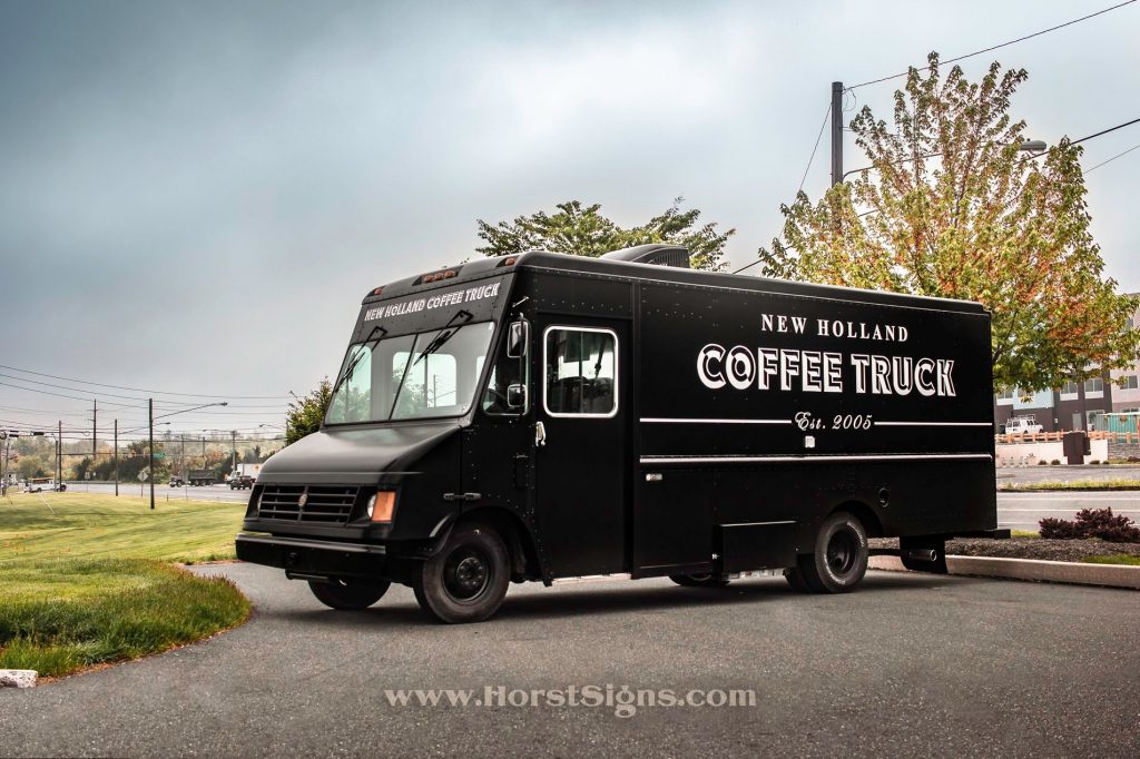 food and coffee truck sitting in a parking lot